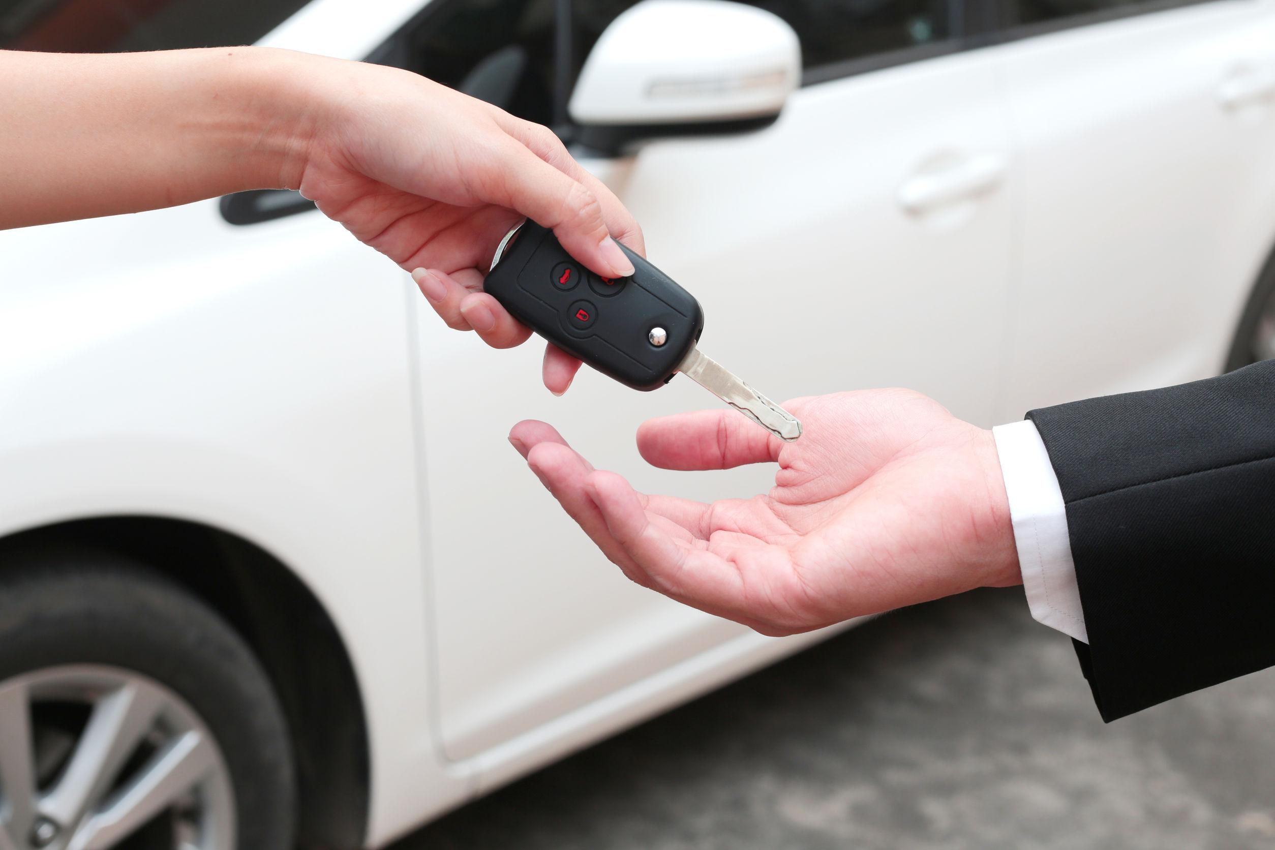 Person giving Car Keys To Another Person