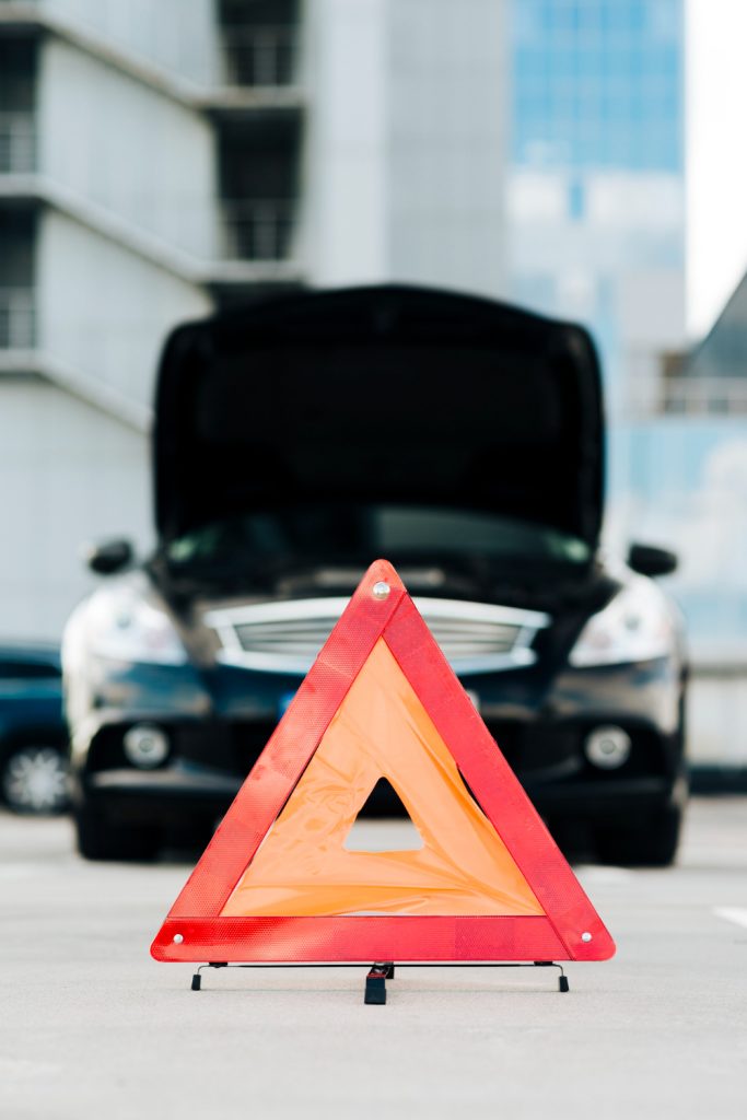 emergency sign with black car background