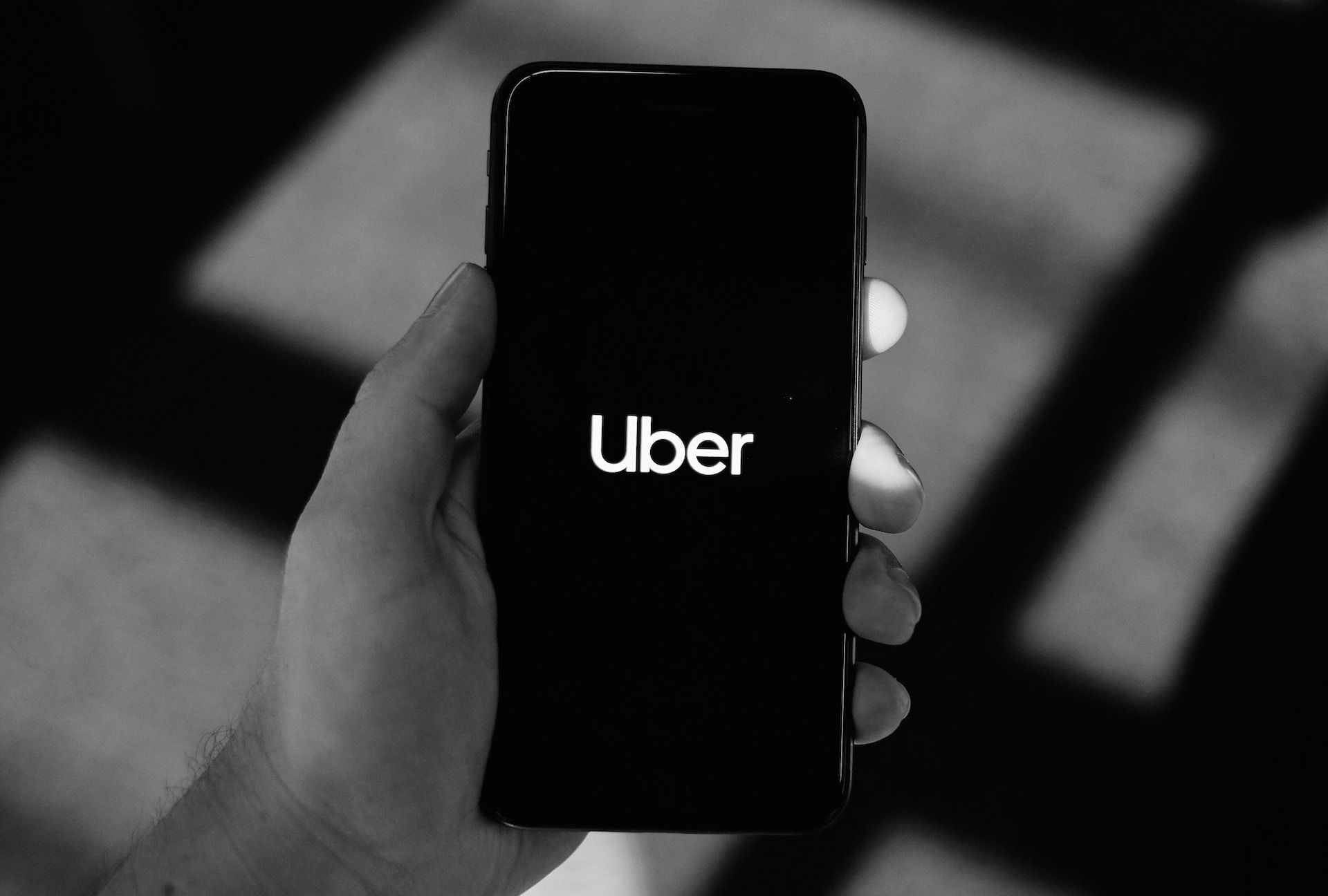 Person Holding Phone While Opening Uber App